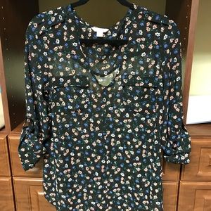 Women’s blouse with multicolored floral designs.